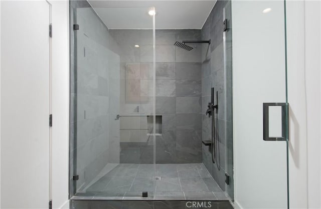 bathroom featuring tile patterned flooring and a shower with shower door