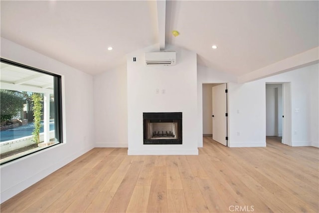 unfurnished living room with light wood-type flooring, vaulted ceiling with beams, and a wall unit AC