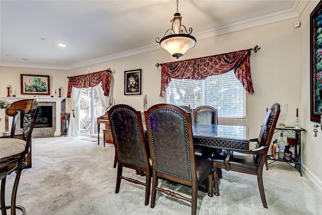 carpeted dining area featuring crown molding and a tile fireplace