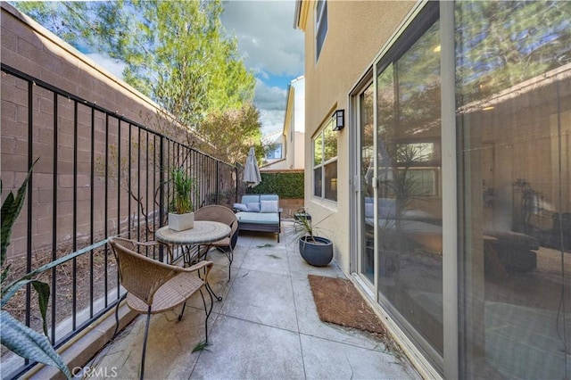 balcony with an outdoor living space and a patio