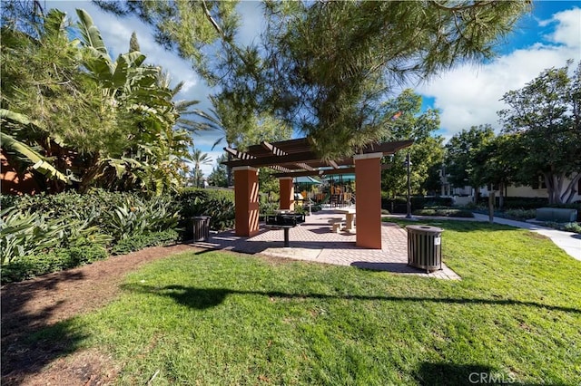 view of property's community with a lawn and a pergola