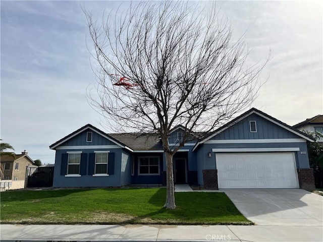 view of front of property with a garage and a front lawn