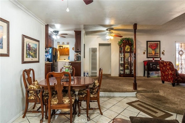 dining space with ornamental molding, light colored carpet, a textured ceiling, and ceiling fan