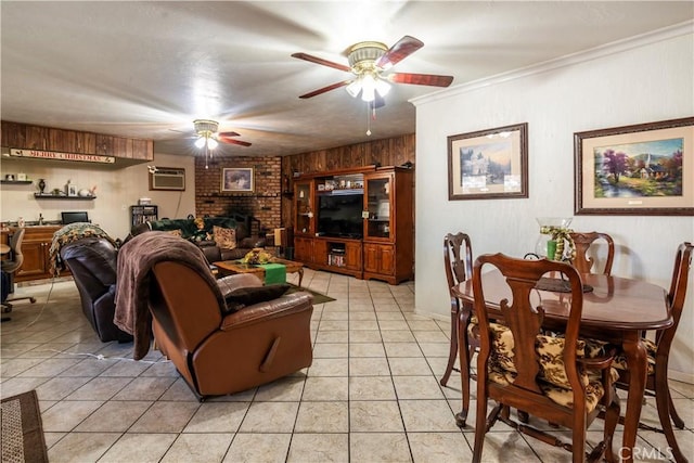 tiled living room featuring wood walls, ornamental molding, ceiling fan, a brick fireplace, and a wall unit AC