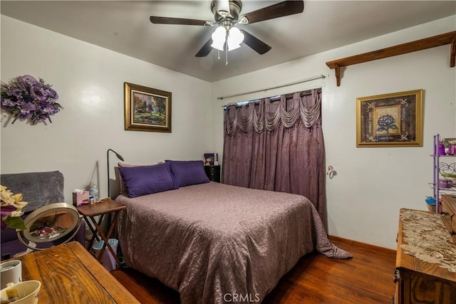 bedroom with dark wood-type flooring and ceiling fan