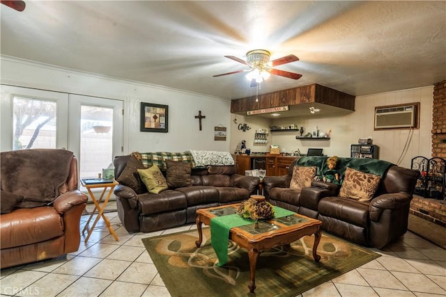 tiled living room with a wall unit AC, ornamental molding, ceiling fan, bar area, and a textured ceiling