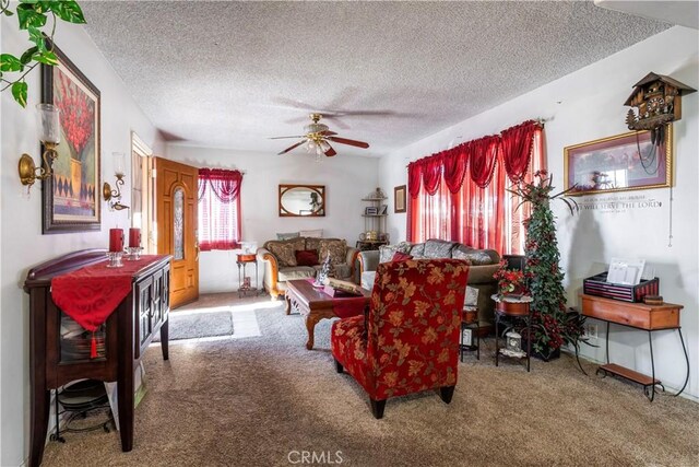 living room featuring ceiling fan, a textured ceiling, and carpet flooring