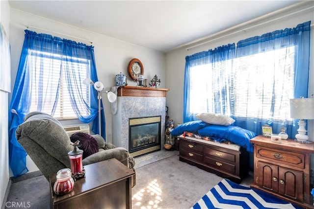 carpeted living room featuring a healthy amount of sunlight and a tile fireplace