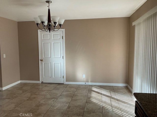 spare room with a chandelier