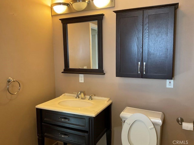 bathroom featuring toilet and vanity