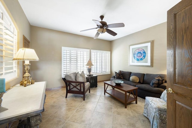 living room with ceiling fan and light tile patterned flooring