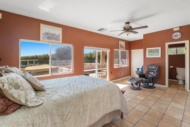 tiled bedroom with ceiling fan, ensuite bathroom, and access to outside