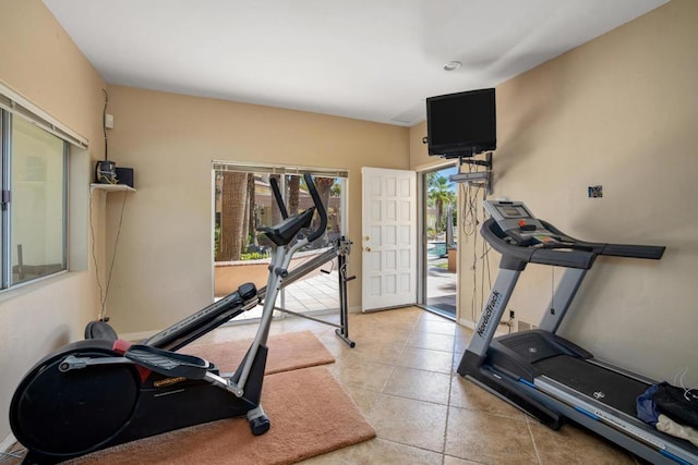 workout room featuring light tile patterned flooring