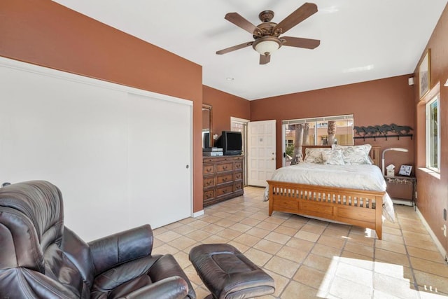 bedroom with ceiling fan and light tile patterned floors