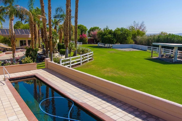 view of swimming pool featuring a yard