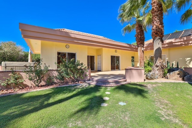 rear view of property with a patio and a yard