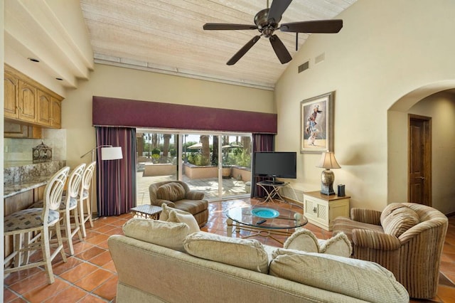 tiled living room featuring high vaulted ceiling, ceiling fan, and wood ceiling