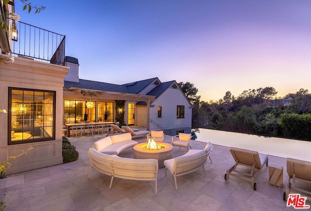 patio terrace at dusk with an outdoor fire pit