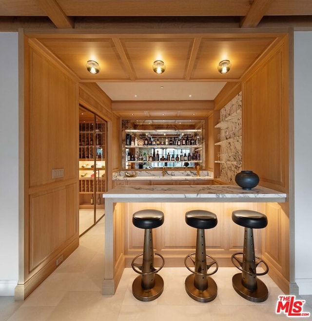 bar featuring coffered ceiling, wooden walls, built in features, and wood ceiling