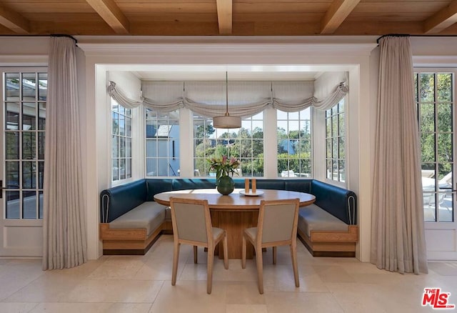 sunroom with breakfast area, a wealth of natural light, beam ceiling, and wooden ceiling