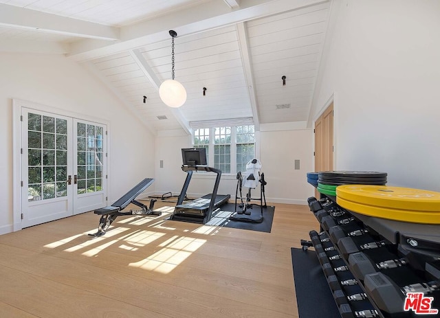 workout area featuring vaulted ceiling, a wealth of natural light, and light hardwood / wood-style floors