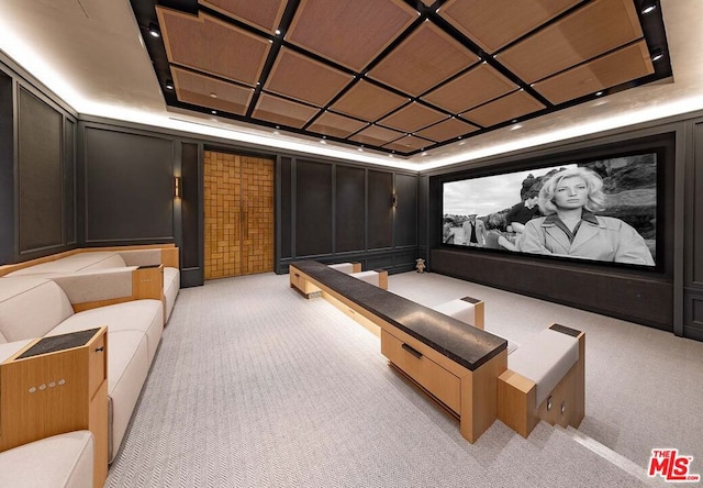 carpeted cinema featuring a tray ceiling