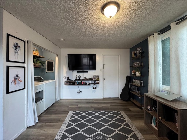 interior space featuring separate washer and dryer, a textured ceiling, and dark hardwood / wood-style floors