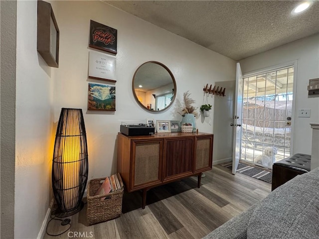 interior space with hardwood / wood-style flooring and a textured ceiling