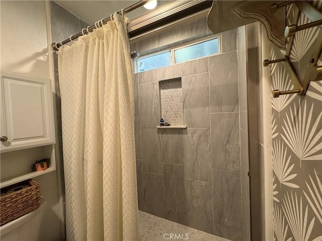 bathroom featuring toilet and a shower with curtain