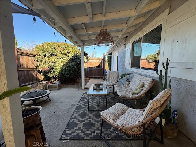 view of patio featuring an outdoor living space with a fire pit