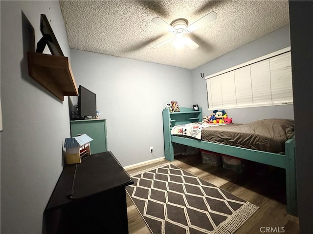 bedroom featuring ceiling fan, a textured ceiling, and wood-type flooring