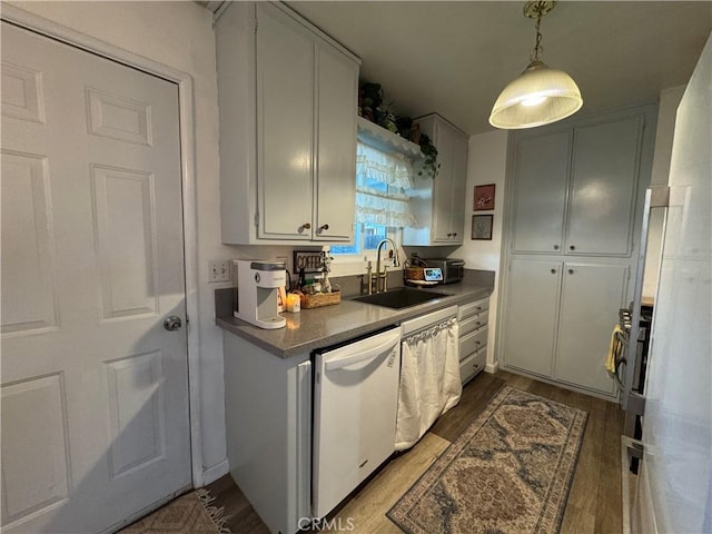 kitchen featuring white dishwasher, sink, and hardwood / wood-style floors