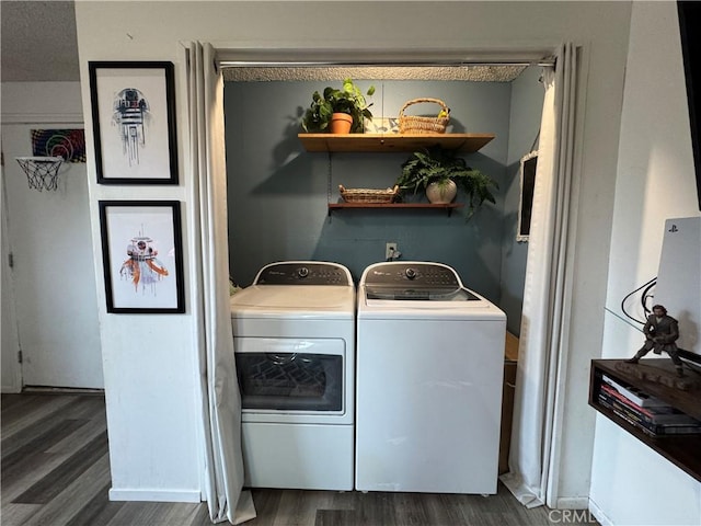 laundry room with dark wood-type flooring and washing machine and clothes dryer