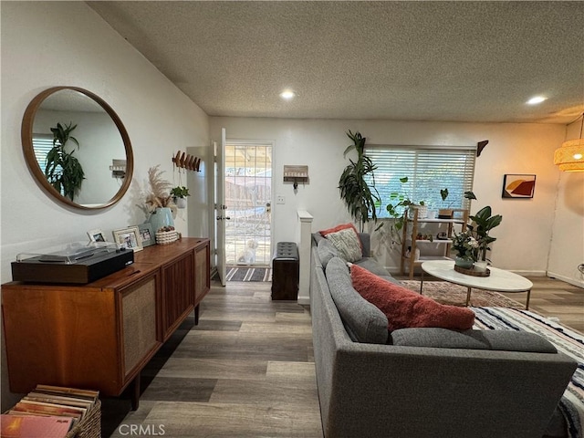 living room featuring a textured ceiling and hardwood / wood-style floors