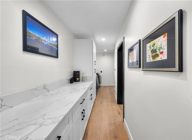 hall featuring light wood-type flooring and washer / dryer