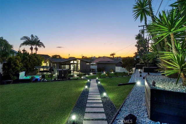 view of yard at dusk