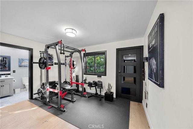 exercise room featuring light wood-type flooring