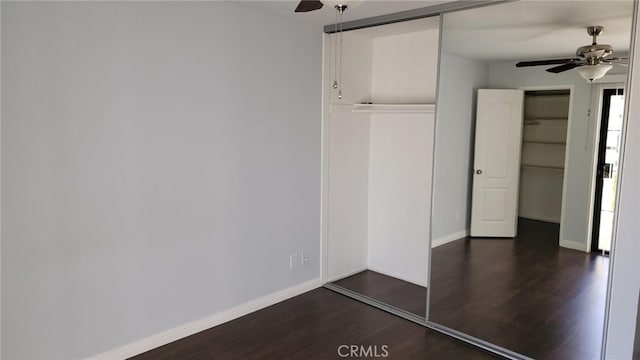 unfurnished bedroom with dark wood-type flooring, ceiling fan, and a closet