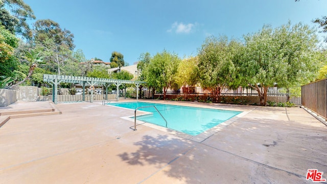 view of pool featuring a patio area and a pergola