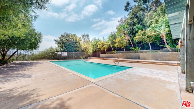 view of swimming pool with a patio area