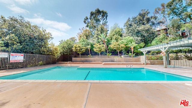 view of swimming pool featuring a pergola