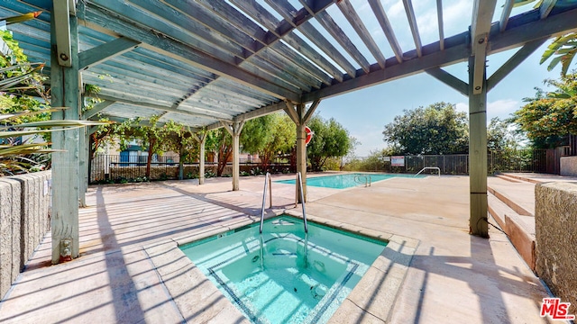 view of swimming pool with a patio and a community hot tub