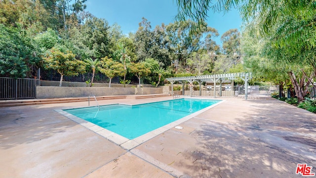 view of pool with a patio and a pergola