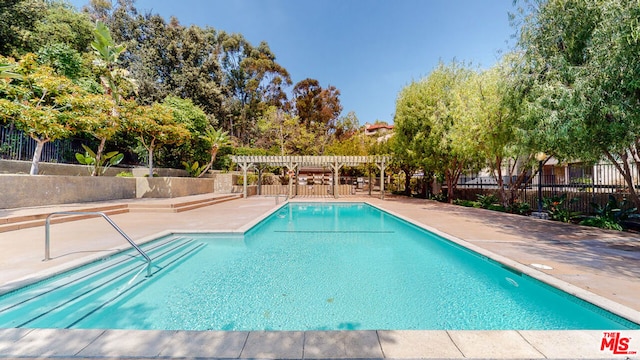 view of pool with a patio area and a pergola