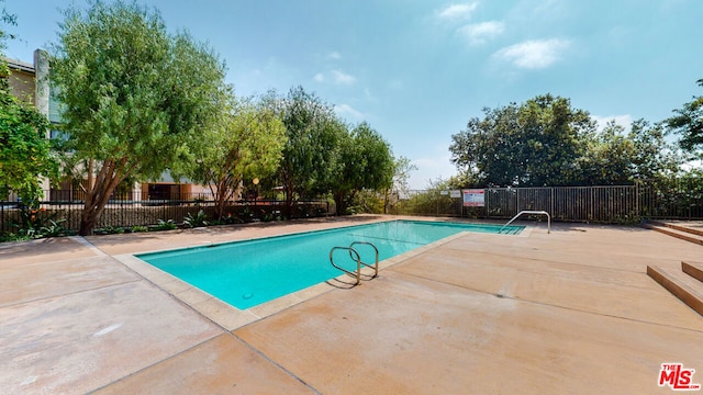 view of swimming pool with a patio area