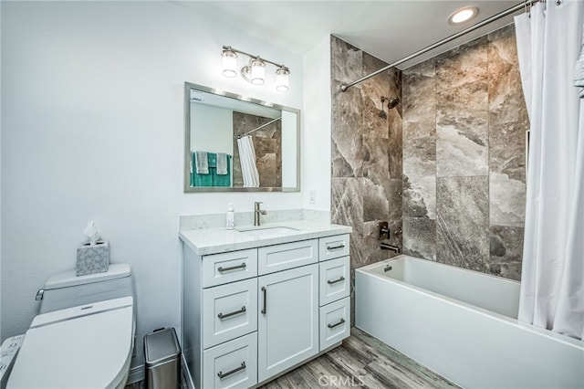 full bathroom featuring hardwood / wood-style floors, toilet, vanity, and shower / bathtub combination with curtain