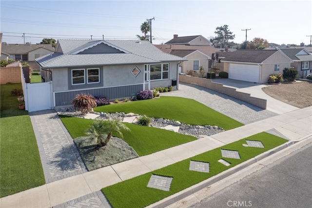 ranch-style house featuring a garage and a front lawn