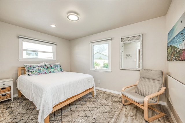 bedroom with hardwood / wood-style flooring