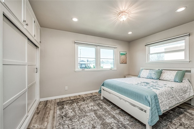 bedroom featuring hardwood / wood-style flooring and multiple windows