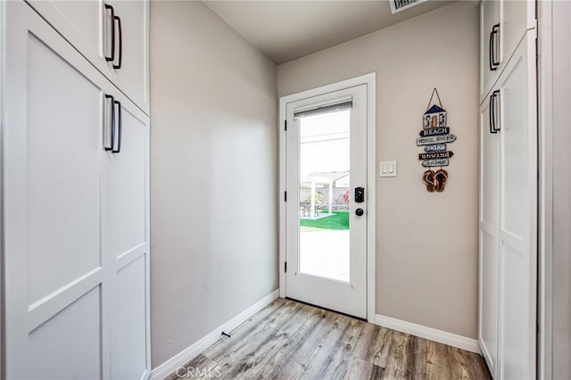 doorway with light wood-type flooring